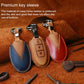 Nissan leather key protective cover set, blue, tan, and red with keyrings