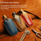 Leather key sleeves in blue, tan, and red with metal key rings and stitching
