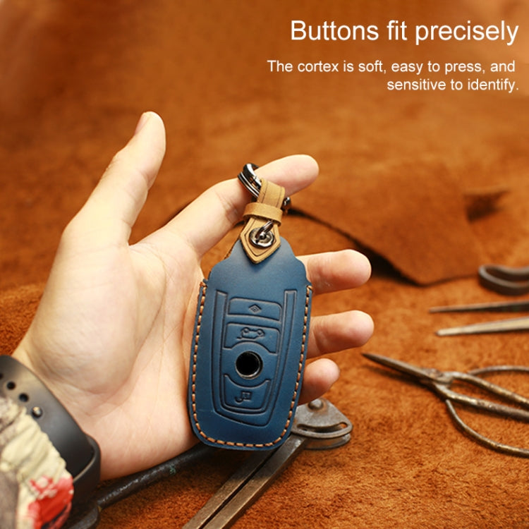 Blue leather key cover case held in hand with key ring and button panel
