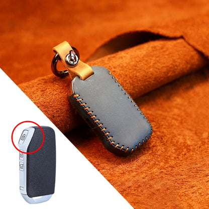 Blue leather key cover with metal ring, side strap, and stitched edges