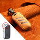 Brown round leather key protective cover with metal key ring and tan strap