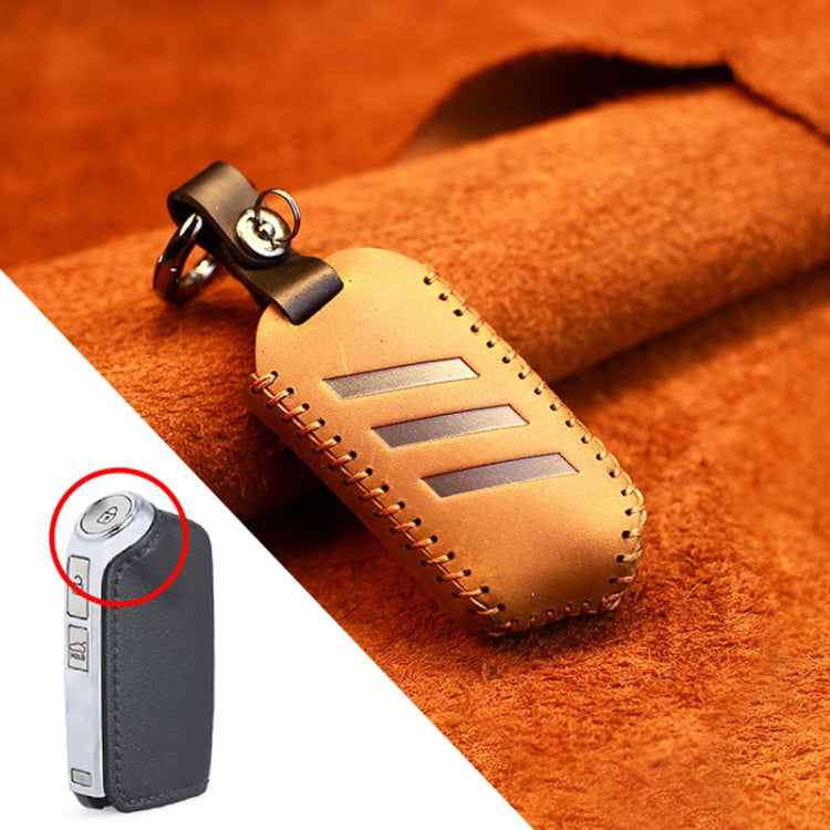 Brown round leather key protective cover with metal key ring and tan strap