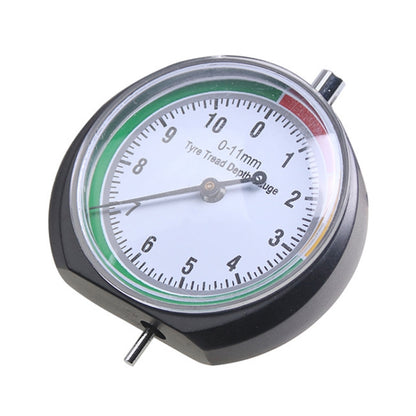 Round tire tread depth gauge with pointer dial, clear window, and black housing