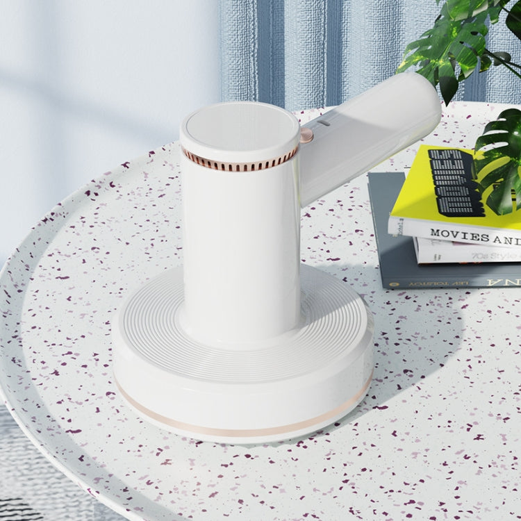 White handheld cordless vacuum with round charging stand base and angled nozzle