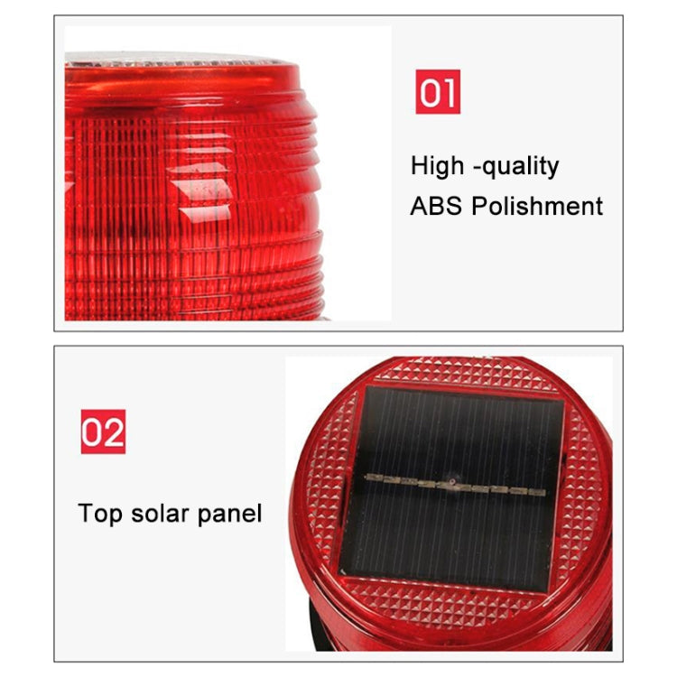 Close-up of red round solar warning light lens with top solar panel