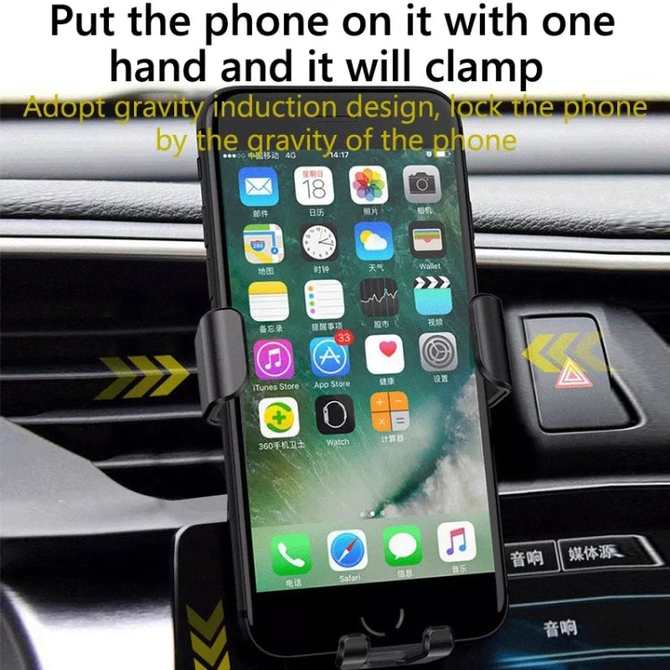 Black gravity-induction wireless charger clamp holding a smartphone