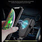 Black wireless car charger stand charging a smartphone with glowing charging icon