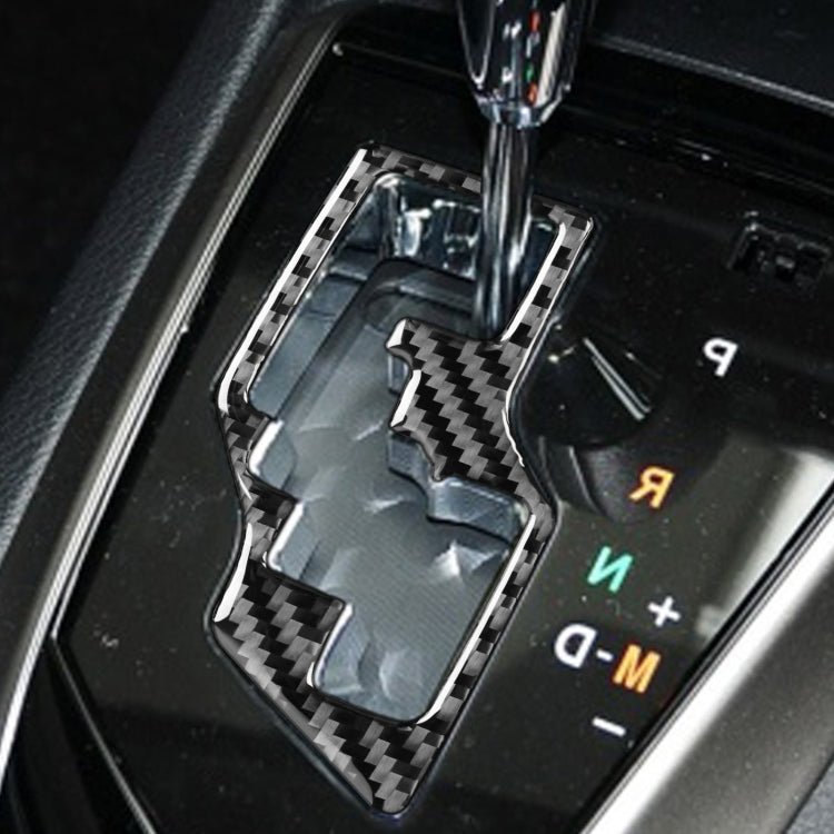Installed carbon-fiber gear trim insert with black outline on automatic shifter area