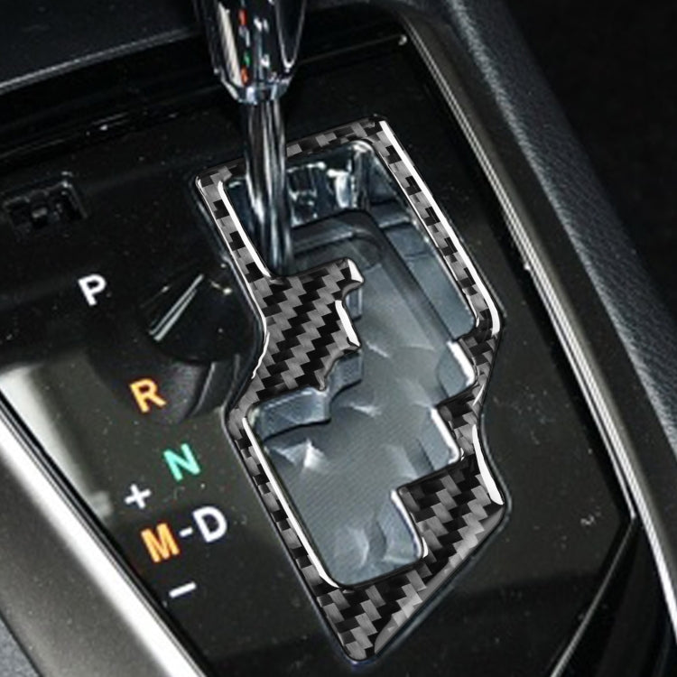 Installed carbon fiber-look gear shift trim on shifter area, black and gray