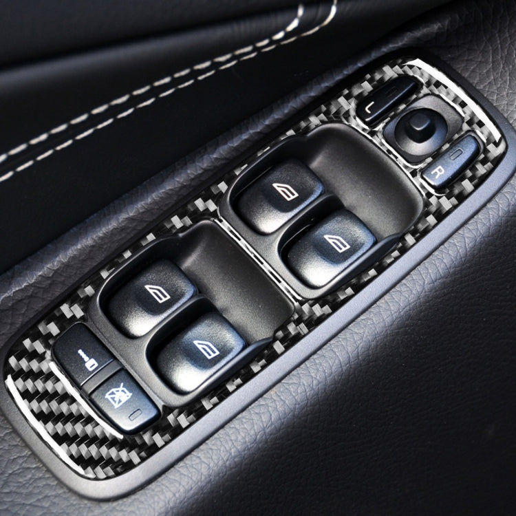 Carbon fiber window switch trim frame installed on a car door control panel