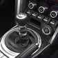 Installed carbon fiber gear console trim around manual shifter with stitched boot