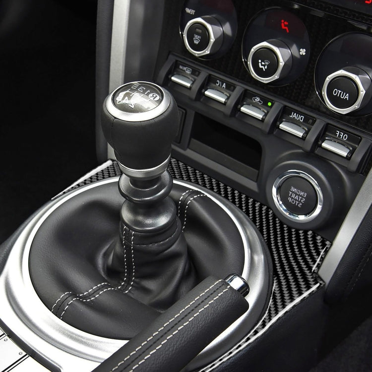 Installed carbon fiber gear console trim around manual shifter with stitched boot