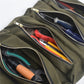 Army green canvas tool bag with zip compartments holding assorted tools