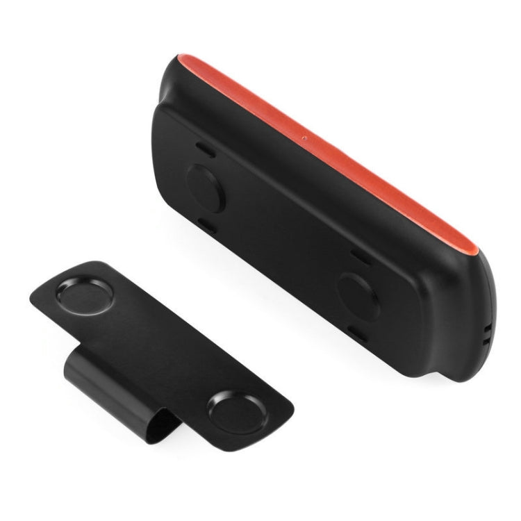 Black car speakerphone with orange trim and mounting clip, side view with control