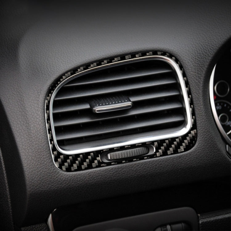 Installed carbon-fiber style air outlet trim around dashboard vent, black weave border