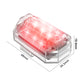 Motorcycle strobe light with red lens, clear body, angled side view