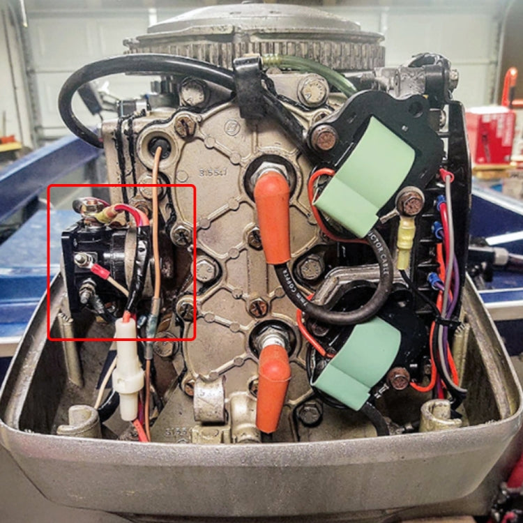 Marine outboard starter solenoid relay mounted in engine bay with visible wiring