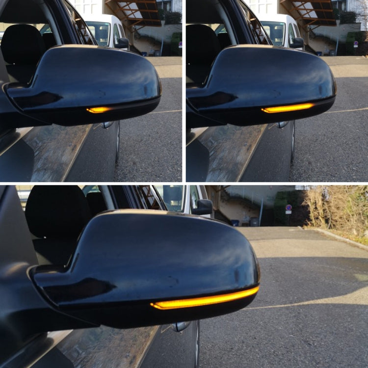 Car side mirrors with amber LED turn signal lights illuminated on both mirrors.