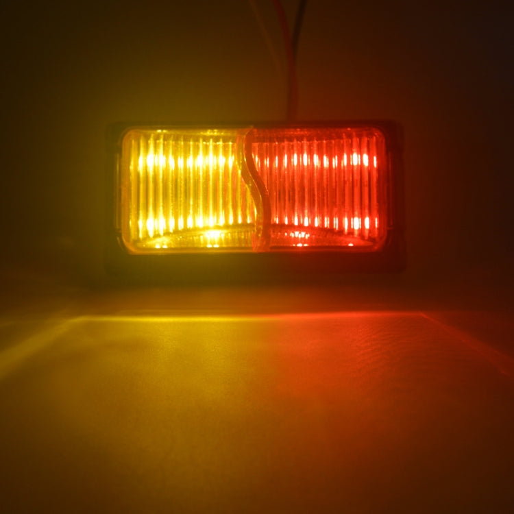 Glowing truck side marker light showing amber left and red right LEDs