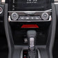 Installed red carbon-fiber style storage trim insert in center console