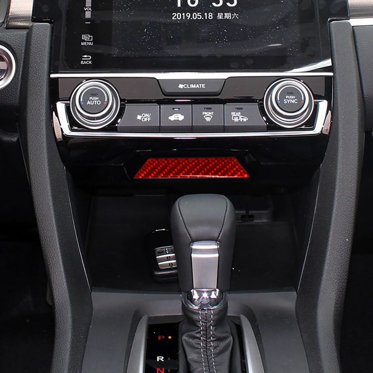 Installed red carbon-fiber style storage trim insert in center console
