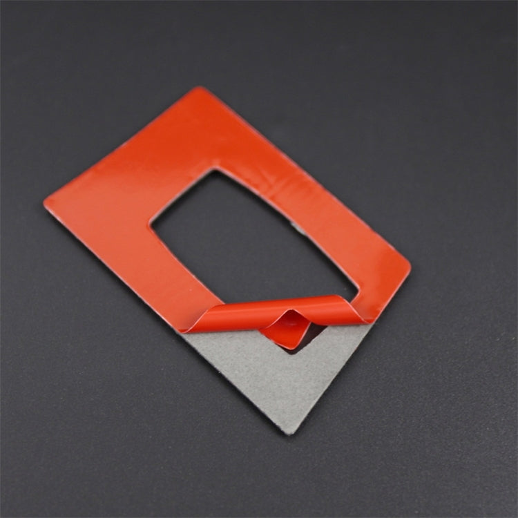 Ignition switch trim sticker piece with orange protective backing and square cutout