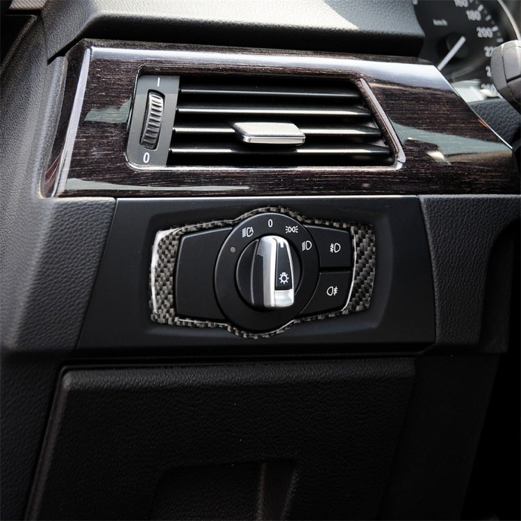 Carbon fiber headlight switch trim sticker installed, surrounding the rotary headlight control