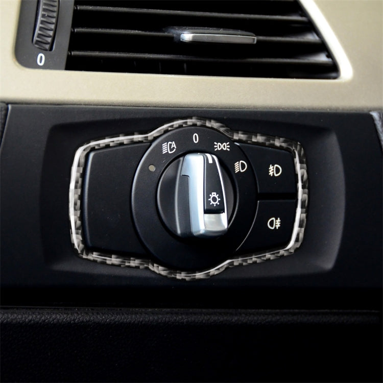 Headlight switch trim sticker with carbon-fiber style border on black control knob