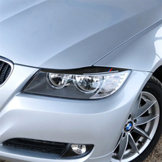 Carbon fiber headlight eyebrow sticker strip over front lamp, black with blue and red accents
