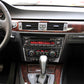 Carbon fiber CD panel trim sticker for BMW center console, installed over audio controls
