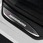 Close-up carbon fiber door sill sticker showing 'Performance' logo and blue-red emblem.