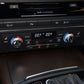 Car climate control panel with two carbon-fiber AC knob button stickers installed