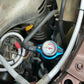 Radiator cap water thermometer accessory installed in engine bay with blue gauge
