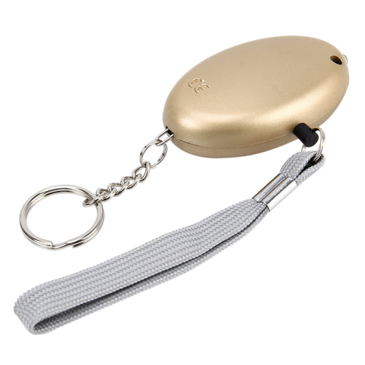 Gold mini personal alarm with gray strap and keyring, side view