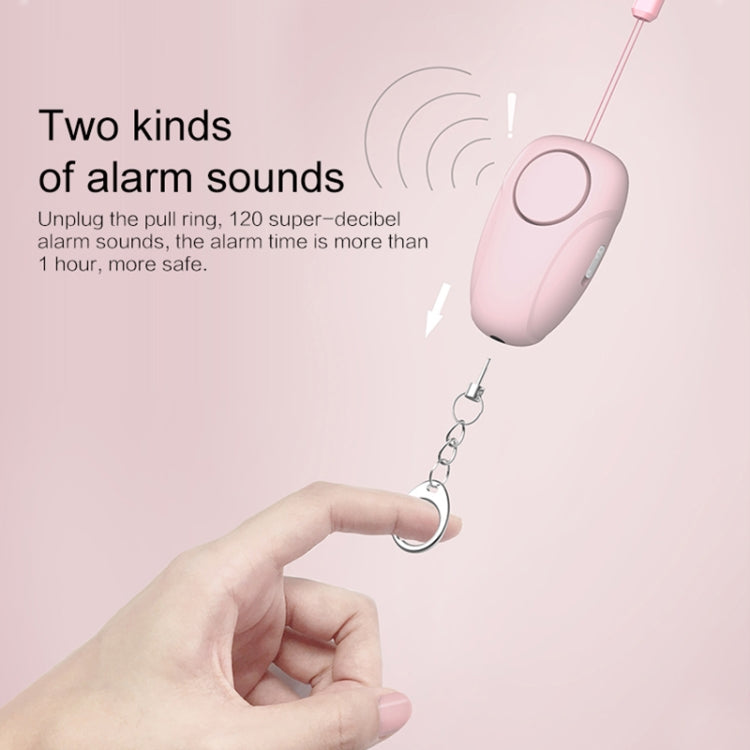 Pink personal alarm siren with pull ring keychain, held in a hand