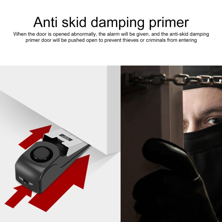 Black wedge door stop alarm with anti-slip base and white pressing plate