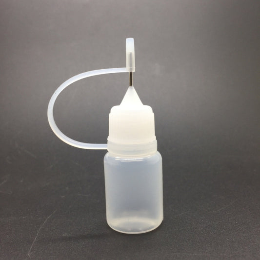 Small PET pinhole oil bottle with white nozzle cap and curved clear tube