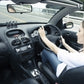 Car interior showing black robot air outlet aromatherapy device near steering area