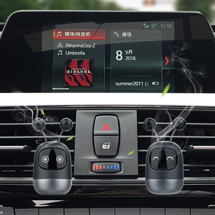 Car dashboard with black robot car air outlet aromatherapy devices attached