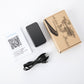 GPS tracker kit with black device, USB cable, instruction sheet, and box