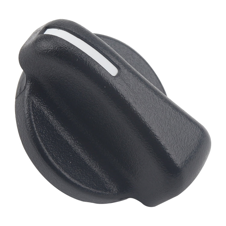 Dark gray air vent control knob with white indicator slot, angled view