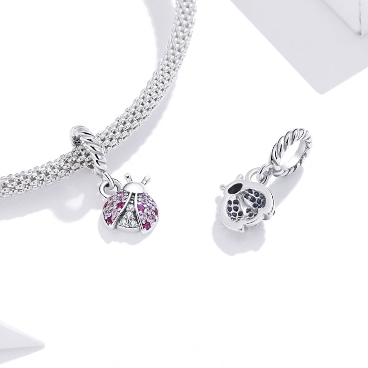Silver charm bracelet with oxidized ladybug pendant on a rhinestone chain