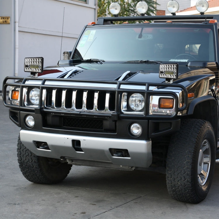 Pair of square LED work lights mounted on an SUV front bumper