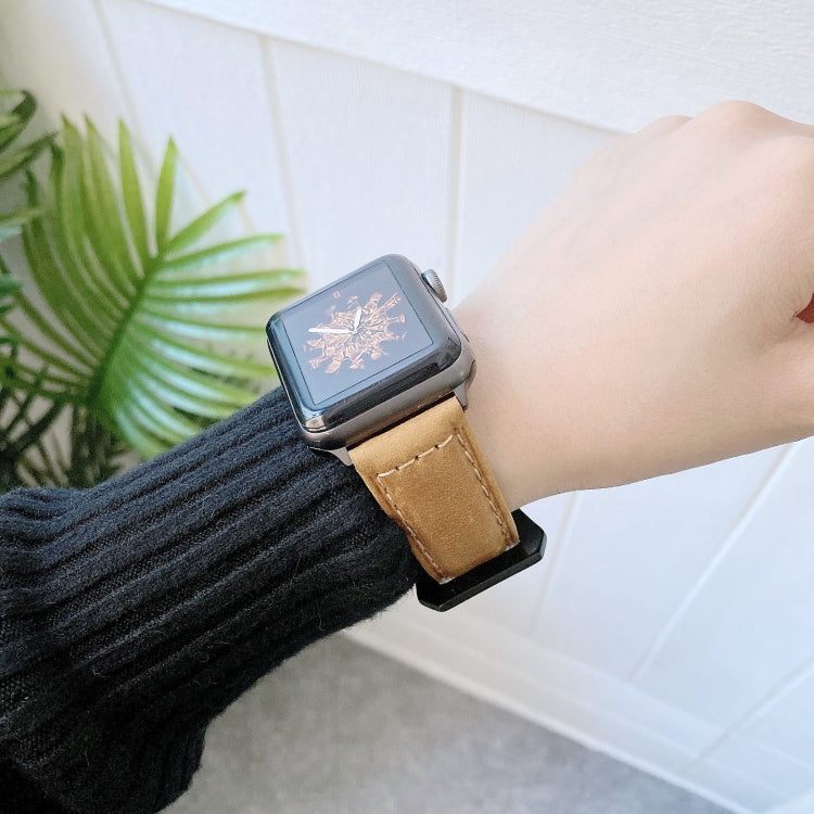 Beige leather buckle watch band with stitched perforated strap on a wrist
