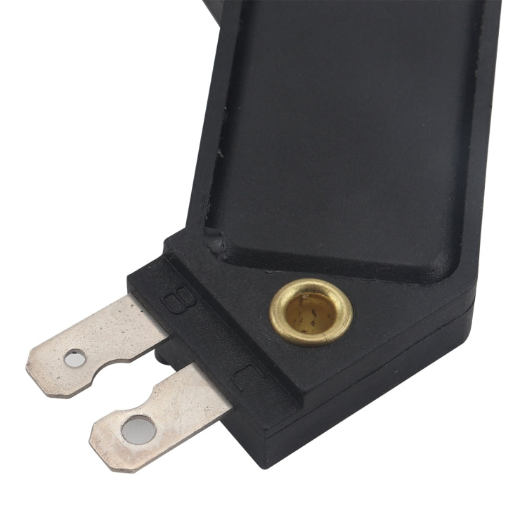 Black ignition control module close-up with brass terminal hole and mounting lugs