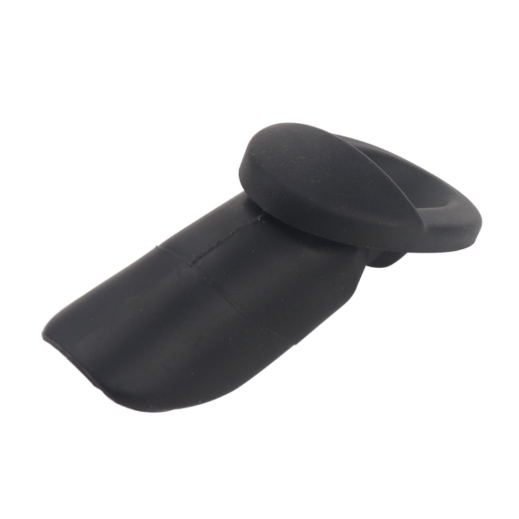 Black antenna base cap with oval head on short cylindrical body, angled view
