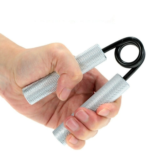 Wrist strength trainer with black spring and silver mesh hand grips, used by a hand