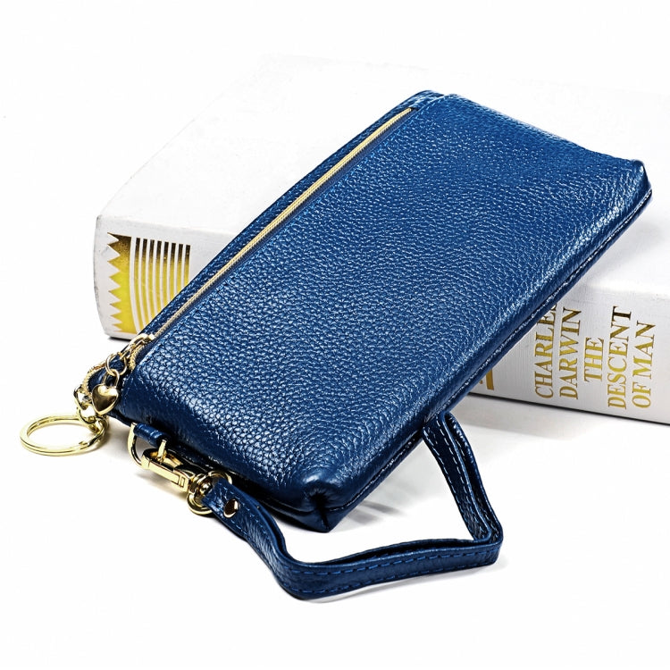 Blue zip coin purse wallet with wrist strap and keyring, side view with cards peeking out.