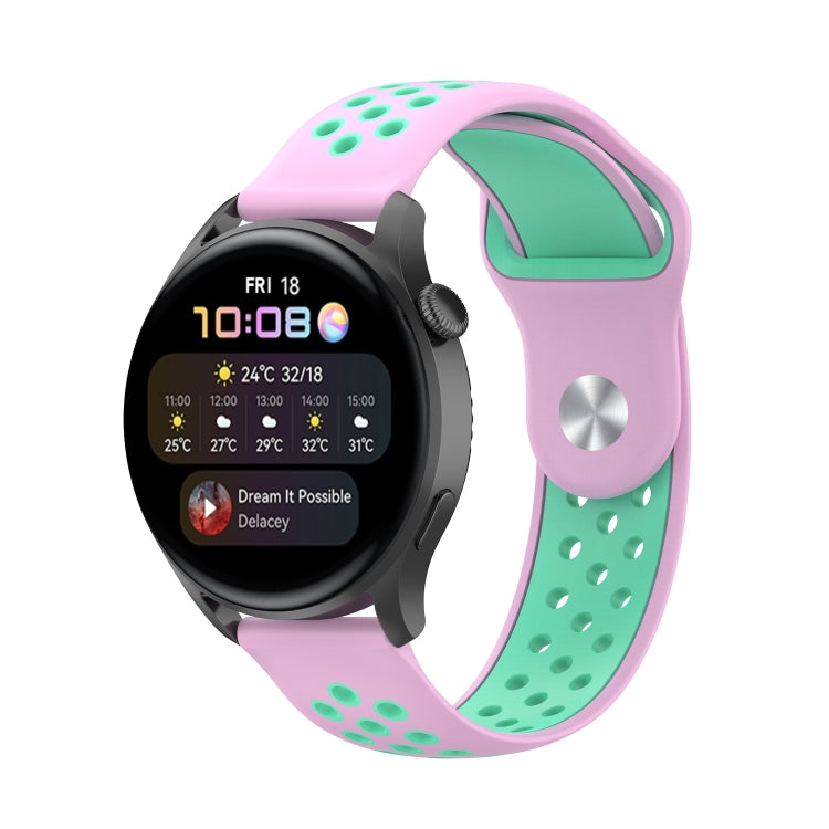 Two-tone silicone watch strap with perforation dots, pink band and mint green accents.