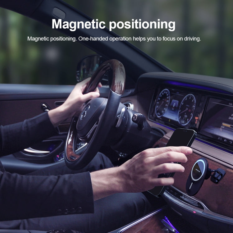 Magnetic car phone holder holding a phone on the dashboard